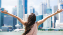 Beautiful asian woman smile and happy to travel in singapore city